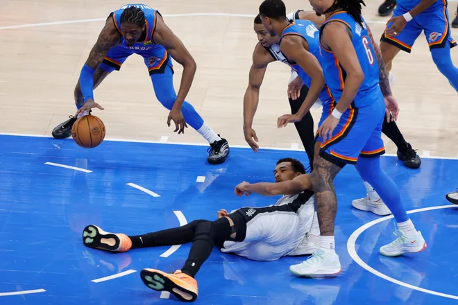 Jan 13, 2026; Oklahoma City, Oklahoma, USA; San Antonio Spurs forward/center Victor Wembanyama (1) falls to the floor and looses the ball during a play against the Oklahoma City Thunder during the second half at Paycom Center. Mandatory Credit: Alonzo Adams-Imagn Images