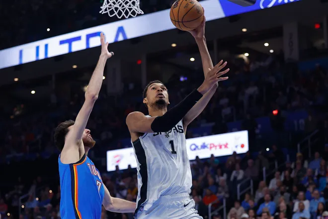 Jan 13, 2026; Oklahoma City, Oklahoma, USA; San Antonio Spurs forward/center Victor Wembanyama (1) goes up for a basket beside Oklahoma City Thunder center/forward Chet Holmgren (7) during the second quarter at Paycom Center. Mandatory Credit: Alonzo Adams-Imagn Images