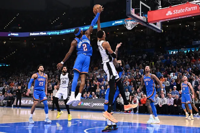 OKLAHOMA CITY, OKLAHOMA - JANUARY 13: Shai Gilgeous-Alexander #2 of the Oklahoma City Thunder blocks a shot attempt by Victor Wembanyama #1 of the San Antonio Spurs during the second half at Paycom Center on January 13, 2026 in Oklahoma City, Oklahoma. NOTE TO USER: User expressly acknowledges and agrees that, by downloading and or using this photograph, User is consenting to the terms and conditions of the Getty Images License Agreement. (Photo by Joshua Gateley/Getty Images)