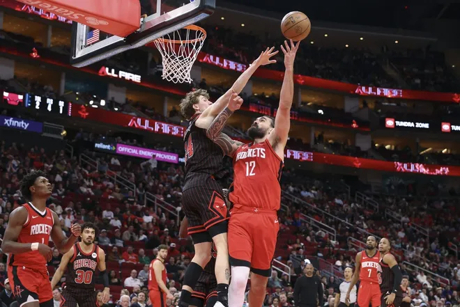 Jan 13, 2026; Houston, Texas, USA; Houston Rockets center Steven Adams (12) shoots the ball as Chicago Bulls forward Matas Buzelis (14) defends during the second half at Toyota Center.