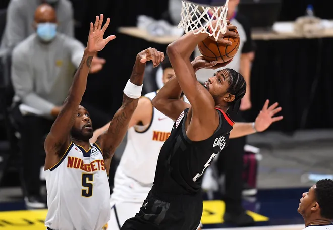 Dec 28, 2020; Denver, Colorado, USA; Houston Rockets forward Bruno Caboclo (5) shoots the ball over Denver Nuggets guard Will Barton (5) in the second half at Ball Arena. Mandatory Credit: Ron Chenoy-USA TODAY Sports