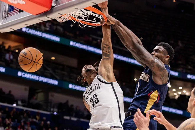Jan 14, 2026; New Orleans, Louisiana, USA; New Orleans Pelicans forward Zion Williamson (1) dunks the ball against Brooklyn Nets center Nic Claxton (33) during the second half at Smoothie King Center.