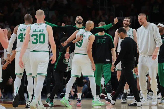 Mar 14, 2025; Miami, Florida, USA; Boston Celtics forward Jayson Tatum (0) celebrates with guard Derrick White (9) against the Miami Heat during the fourth quarter at Kaseya Center. Mandatory Credit: Sam Navarro-Imagn Images