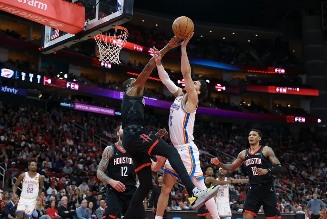 Jan 15, 2026; Houston, Texas, USA; Oklahoma City Thunder guard Ajay Mitchell (25) shoots the ball as Houston Rockets forward Kevin Durant (7) defends during the third quarter at Toyota Center. Mandatory Credit: Troy Taormina-Imagn Images