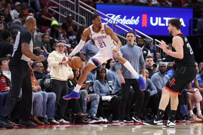 Jan 15, 2026; Houston, Texas, USA; Oklahoma City Thunder guard Aaron Wiggins (21) attempts to save a ball from going out of bounds during the third quarter against the Houston Rockets at Toyota Center. Mandatory Credit: Troy Taormina-Imagn Images