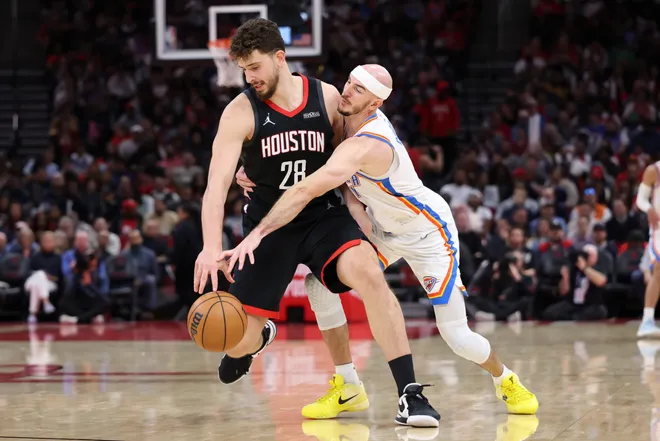 Jan 15, 2026; Houston, Texas, USA; Oklahoma City Thunder guard Alex Caruso (9) attempts to steal the ball from Houston Rockets center Alperen Sengun (28) during the third quarter at Toyota Center. Mandatory Credit: Troy Taormina-Imagn Images