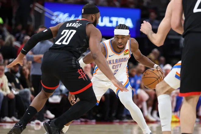 Jan 15, 2026; Houston, Texas, USA; Oklahoma City Thunder guard Shai Gilgeous-Alexander (2) dribbles the ball as Houston Rockets guard Josh Okogie (20) defends during the third quarter at Toyota Center. Mandatory Credit: Troy Taormina-Imagn Images