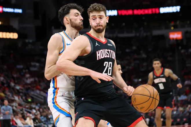 Jan 15, 2026; Houston, Texas, USA; Houston Rockets center Alperen Sengun (28) attempts to dribble the ball around Oklahoma City Thunder center Chet Holmgren (7) during the second quarter at Toyota Center. Mandatory Credit: Troy Taormina-Imagn Images