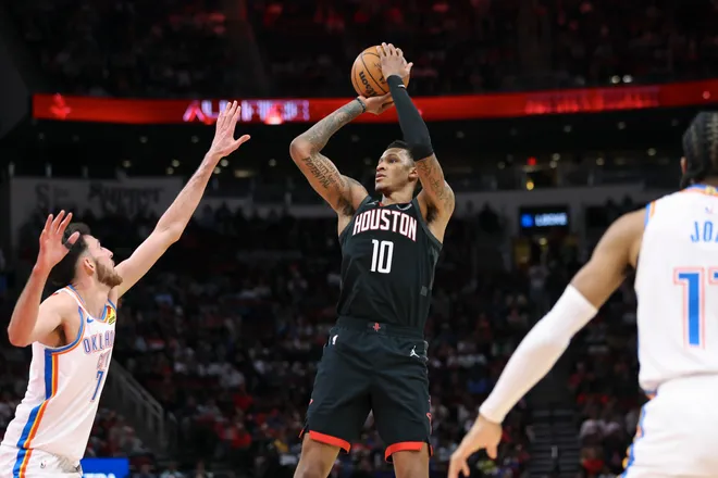 Jan 15, 2026; Houston, Texas, USA; Houston Rockets forward Jabari Smith Jr. (10) shoots the ball as Oklahoma City Thunder center Chet Holmgren (7) defends during the second quarter at Toyota Center. Mandatory Credit: Troy Taormina-Imagn Images