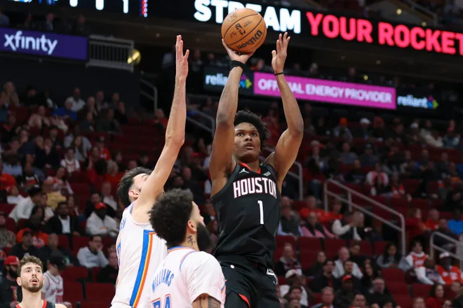 Jan 15, 2026; Houston, Texas, USA; Houston Rockets guard Amen Thompson (1) shoots the ball as Oklahoma City Thunder center Chet Holmgren (7) defends during the second quarter at Toyota Center. Mandatory Credit: Troy Taormina-Imagn Images