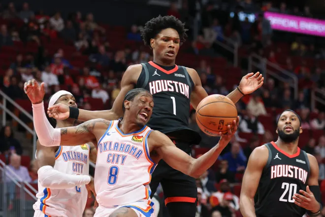 Jan 15, 2026; Houston, Texas, USA; Oklahoma City Thunder guard Jalen Williams (8) attempts to get control of the ball from Houston Rockets guard Amen Thompson (1) during the first quarter at Toyota Center. Mandatory Credit: Troy Taormina-Imagn Images