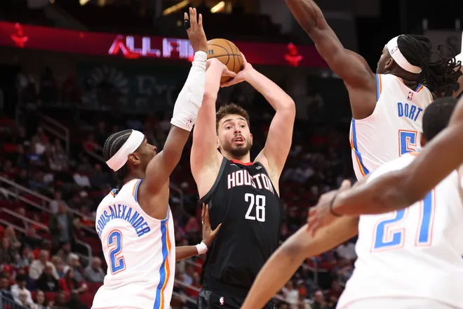 Jan 15, 2026; Houston, Texas, USA; Houston Rockets center Alperen Sengun (28) looks to pass the ball as Oklahoma City Thunder guard Shai Gilgeous-Alexander (2) defends during the first quarter at Toyota Center. Mandatory Credit: Troy Taormina-Imagn Images