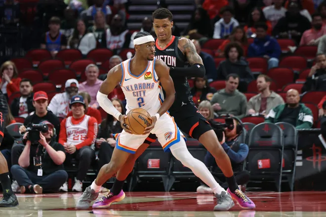Jan 15, 2026; Houston, Texas, USA; Oklahoma City Thunder guard Shai Gilgeous-Alexander (2) controls the ball as Houston Rockets forward Jabari Smith Jr. (10) defends during the first quarter at Toyota Center. Mandatory Credit: Troy Taormina-Imagn Images