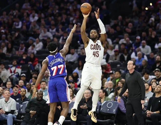 Jan 14, 2026; Philadelphia, Pennsylvania, USA; Cleveland Cavaliers guard Donovan Mitchell (45) shoots past Philadelphia 76ers guard Vj Edgecombe (77) during the fourth quarter at Xfinity Mobile Arena.