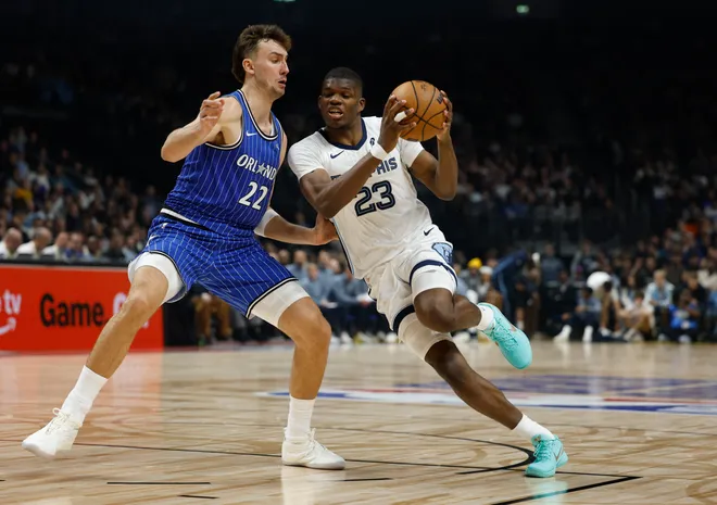 Orlando Magic's German small forward #22 Franz Wagner (L) and Memphis Grizzlies' US shooting guard #23 Cedric Coward vie for the ball during the 2025/2026 NBA season basketball match between Memphis Grizzlies and Orlando Magic on January 15, 2026 in Berlin. (Photo by Odd ANDERSEN / AFP via Getty Images)