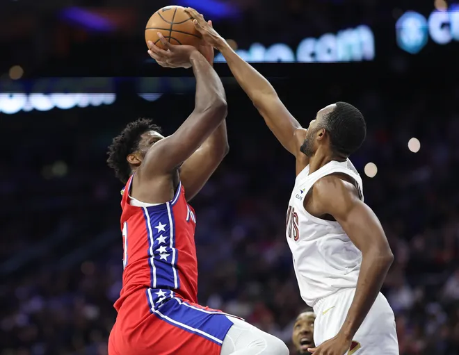 Jan 16, 2026; Philadelphia, Pennsylvania, USA; Cleveland Cavaliers center Evan Mobley (4) blocks the shot of Philadelphia 76ers center Joel Embiid (21) during the second quarter at Xfinity Mobile Arena. Mandatory Credit: Bill Streicher-Imagn Images