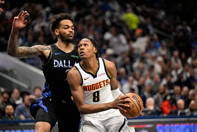 Jan 14, 2026; Dallas, Texas, USA; Denver Nuggets guard Peyton Watson (8) drives to the basket past Dallas Mavericks forward P.J. Washington (25) during the second quarter at the American Airlines Center.
