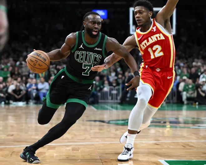 Jan 18, 2025; Boston, Massachusetts, USA; Boston Celtics guard Jaylen Brown (7) drives to the basket against Atlanta Hawks forward De'Andre Hunter (12) during overtime at the TD Garden. Mandatory Credit: Brian Fluharty-Imagn Images