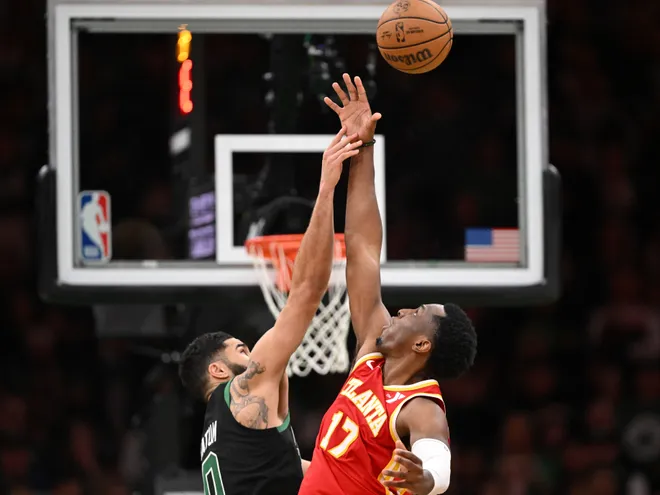 Jan 18, 2025; Boston, Massachusetts, USA; Boston Celtics forward Jayson Tatum (0) and Atlanta Hawks forward Onyeka Okongwu (17) jump for the ball during overtime at the TD Garden. Mandatory Credit: Brian Fluharty-Imagn Images