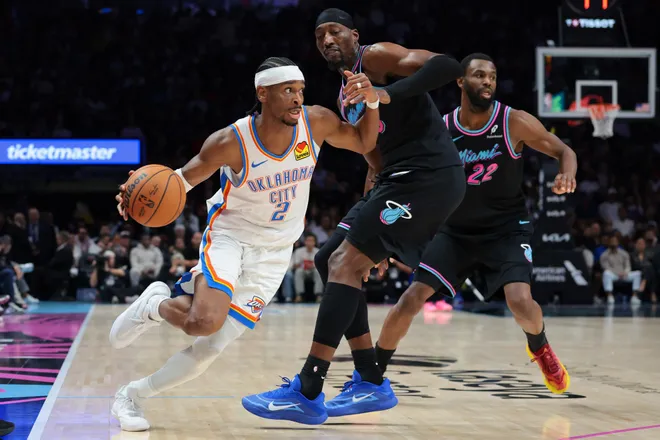 Jan 17, 2026; Miami, Florida, USA; Oklahoma City Thunder guard Shai Gilgeous-Alexander (2) drives to the basket against Miami Heat center Bam Adebayo (13) during the second quarter at Kaseya Center. Mandatory Credit: Sam Navarro-Imagn Images
