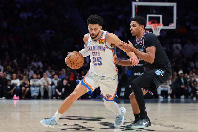 Jan 17, 2026; Miami, Florida, USA; Oklahoma City Thunder guard Ajay Mitchell (25) drives to the basket against Miami Heat guard Dru Smith (12) during the second quarter at Kaseya Center. Mandatory Credit: Sam Navarro-Imagn Images