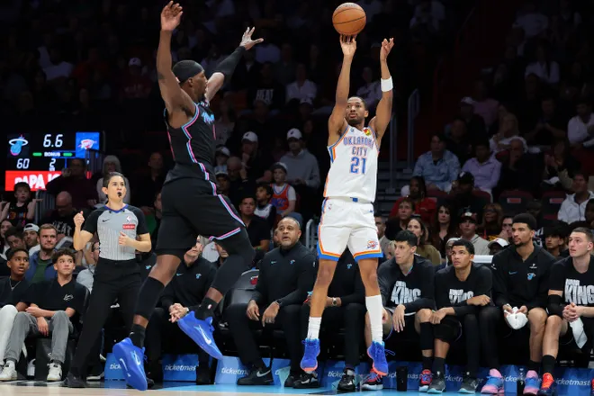Jan 17, 2026; Miami, Florida, USA; Oklahoma City Thunder guard Aaron Wiggins (21) shoots the basketball against Miami Heat center Bam Adebayo (13) during the second quarter at Kaseya Center. Mandatory Credit: Sam Navarro-Imagn Images