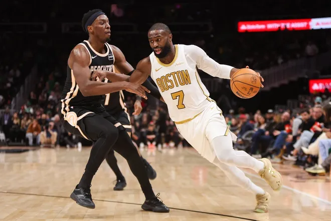 Jan 17, 2026; Atlanta, Georgia, USA; Boston Celtics guard Jaylen Brown (7) drives on Atlanta Hawks forward Onyeka Okongwu (17) in the third quarter at State Farm Arena.