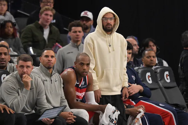 Jan 14, 2026; Inglewood, California, USA; Washington Wizards guard Trae Young (3) (white hoodie) looks on from the bench in the second half against the Los Angeles Clippers at Intuit Dome. Mandatory Credit: Jayne Kamin-Oncea-Imagn Images