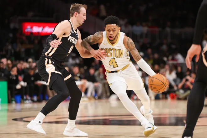 Jan 17, 2026; Atlanta, Georgia, USA; Atlanta Hawks guard Luke Kennard (4) defends Boston Celtics guard Anfernee Simons (4) in the fourth quarter at State Farm Arena. Mandatory Credit: Brett Davis-Imagn Images