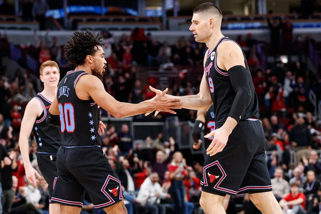 Jan 14, 2026; Chicago, Illinois, USA; Chicago Bulls center Nikola Vucevic (9) celebrates with guard Tre Jones (30) after scoring against the Utah Jazz during the second half at United Center. Mandatory Credit: Kamil Krzaczynski-Imagn Images