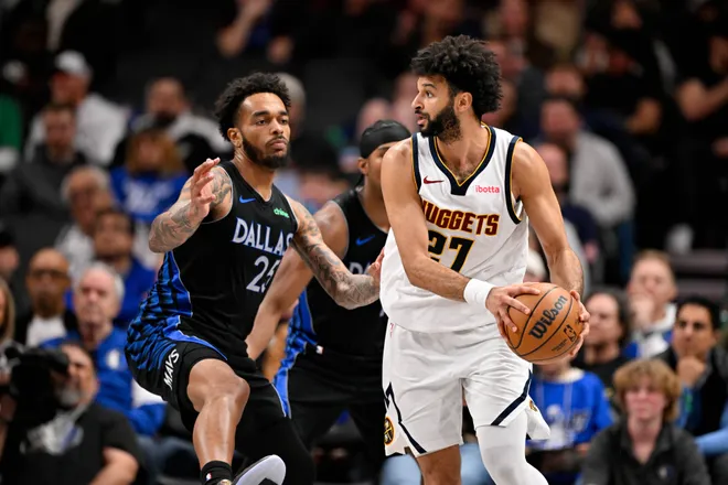 Jan 14, 2026; Dallas, Texas, USA; Denver Nuggets guard Jamal Murray (27) looks to move the ball Dallas Mavericks forward P.J. Washington (25) during the second half at the American Airlines Center. Mandatory Credit: Jerome Miron-Imagn Images