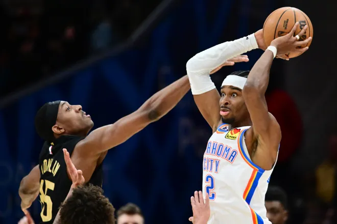 Jan 19, 2026; Cleveland, Ohio, USA; Oklahoma City Thunder guard Shai Gilgeous-Alexander (2) looks to pass against Cleveland Cavaliers forward Nae'qwan Tomlin (35) during the second half at Rocket Arena. Mandatory Credit: Ken Blaze-Imagn Images