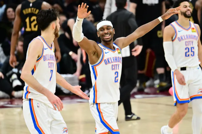 Jan 19, 2026; Cleveland, Ohio, USA; Oklahoma City Thunder guard Luguentz Dort (5) and center Chet Holmgren (7) celebrate after a three point basket during the second half against the Cleveland Cavaliers at Rocket Arena. Mandatory Credit: Ken Blaze-Imagn Images