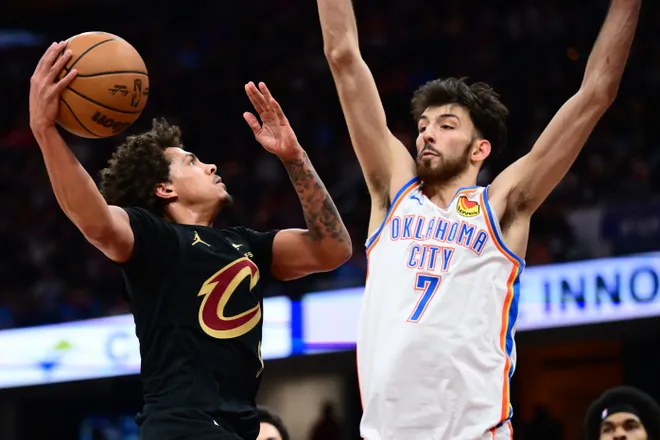 Jan 19, 2026; Cleveland, Ohio, USA; Cleveland Cavaliers guard Craig Porter Jr. (9) drives to the basket against Oklahoma City Thunder center Chet Holmgren (7) during the second half at Rocket Arena. Mandatory Credit: Ken Blaze-Imagn Images