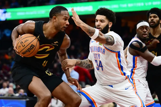 Jan 19, 2026; Cleveland, Ohio, USA; Cleveland Cavaliers center Evan Mobley (4) drives to the basket against Oklahoma City Thunder guard Kenrich Williams (34) during the second half at Rocket Arena. Mandatory Credit: Ken Blaze-Imagn Images