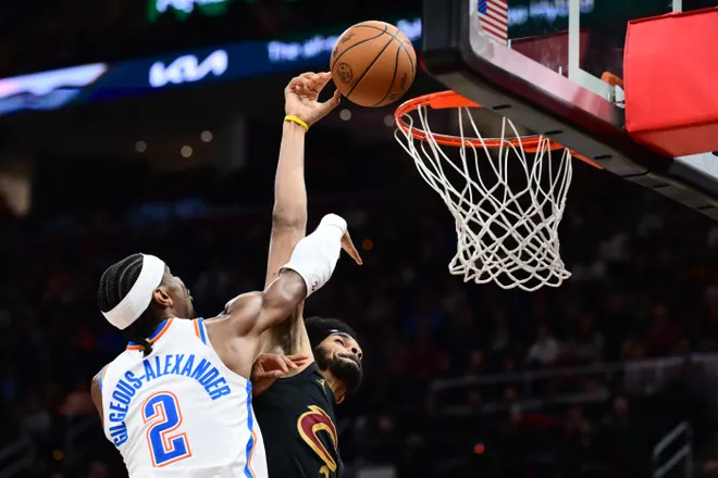 Jan 19, 2026; Cleveland, Ohio, USA; Oklahoma City Thunder guard Shai Gilgeous-Alexander (2) fouls Cleveland Cavaliers center Jarrett Allen (31) during the second half at Rocket Arena. Mandatory Credit: Ken Blaze-Imagn Images
