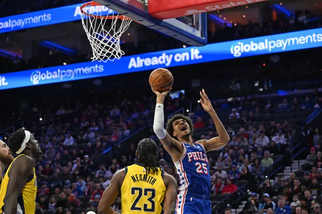 Jan 19, 2026; Philadelphia, Pennsylvania, USA; Philadelphia 76ers forward Dominick Barlow (25) is fouled by Indiana Pacers guard Aaron Nesmith (23) during the first quarter at Xfinity Mobile Arena. Mandatory Credit: Eric Hartline-Imagn Images