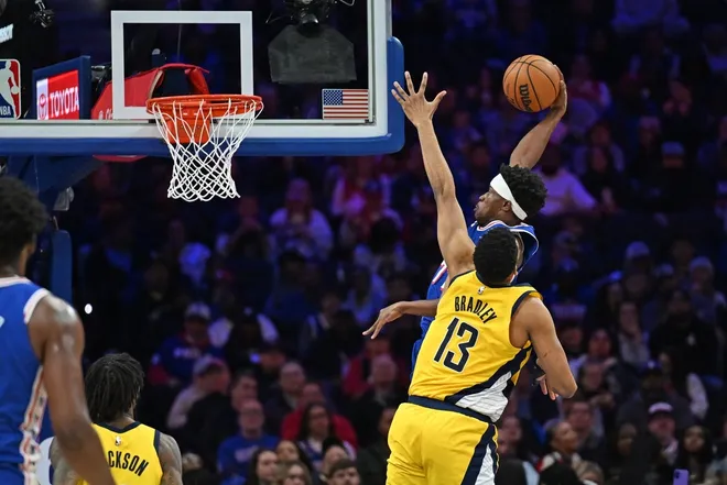 Jan 19, 2026; Philadelphia, Pennsylvania, USA; Philadelphia 76ers guard Vj Edgecombe (77) dunks past Indiana Pacers center Tony Bradley (13) during the second half at Xfinity Mobile Arena.