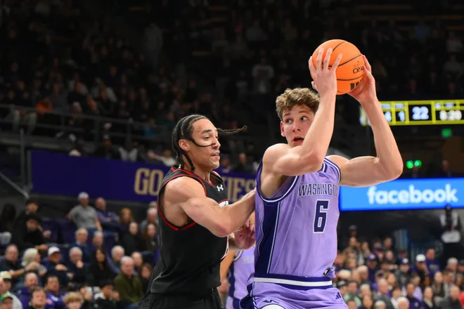 Dec 29, 2025; Seattle, Washington, USA; Washington Huskies forward Hannes Steinbach (6) looks to pass the ball while guarded by Utah Utes forward Keanu Dawes (8) during the first half at Alaska Airlines Arena at Hec Edmundson Pavilion. Mandatory Credit: Steven Bisig-Imagn Images