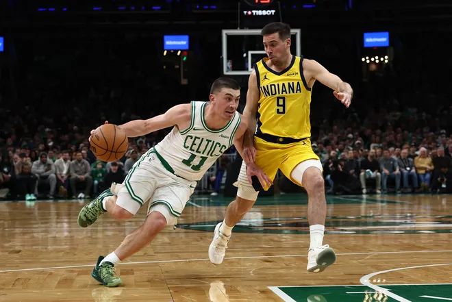 Jan 21, 2026; Boston, Massachusetts, USA; Boston Celtics guard Payton Pritchard (11) drives on Indiana Pacers guard T.J. McConnell (9) during the first quarter at TD Garden. Mandatory Credit: Winslow Townson-Imagn Images