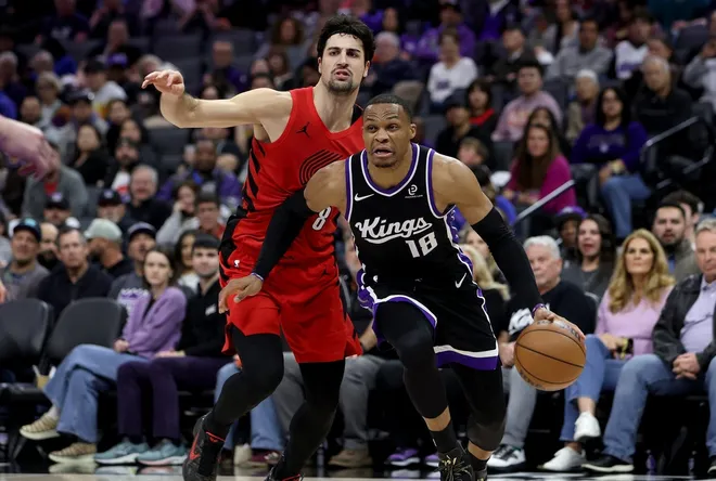 Jan 18, 2026; Sacramento, California, USA; Sacramento Kings guard Russel Westbrook (18) drives around Portland Trail Blazers forward Deni Avdija (8) during the fourth quarter at Golden 1 Center.