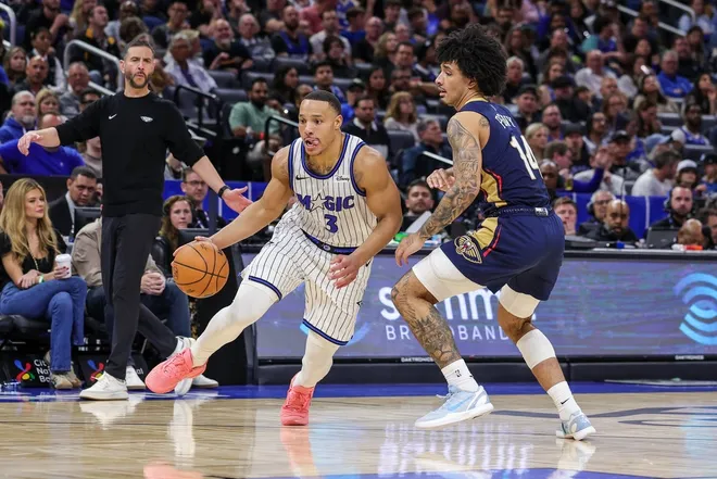 Jan 11, 2026; Orlando, Florida, USA; Orlando Magic guard Desmond Bane (3) drives past New Orleans Pelicans guard Micah Peavy (14) during the second half at Kia Center.