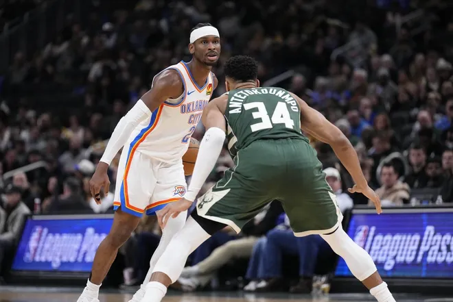 Jan 21, 2026; Milwaukee, Wisconsin, USA; Oklahoma City Thunder guard Shai Gilgeous-Alexander (2) drives against Milwaukee Bucks forward Giannis Antetokounmpo (34) in the first half at Fiserv Forum.