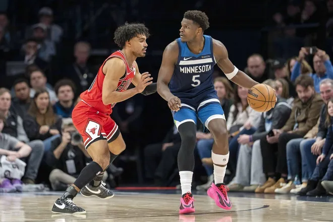 Jan 22, 2026; Minneapolis, Minnesota, USA; Minnesota Timberwolves guard Anthony Edwards (5) dribbles the ball as Chicago Bulls guard Tre Jones (30) defends in the second half at Target Center.