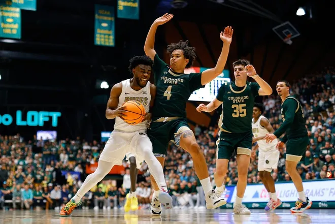 Dec 6, 2025; Fort Collins, Colorado, USA; Colorado Buffaloes guard Barrington Hargress (24) drives to the basket against Colorado State Rams guard Jase Butler (4) as forward Kyle Jorgensen (35) defends in the second half at Moby Arena.