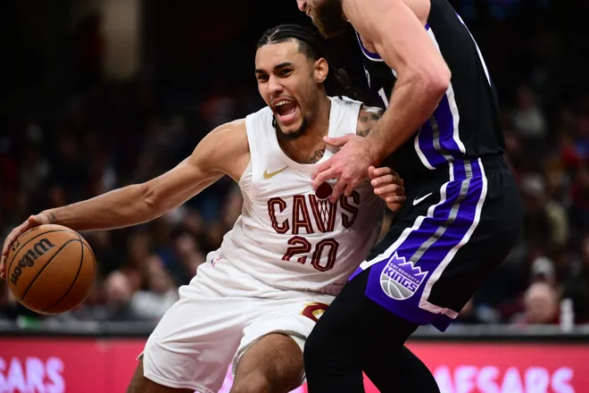 Jan 23, 2026; Cleveland, Ohio, USA; Cleveland Cavaliers guard Jaylon Tyson (20) drives to the basket against Sacramento Kings forward Domantas Sabonis (11) during the second half at Rocket Arena. Mandatory Credit: Ken Blaze-Imagn Images