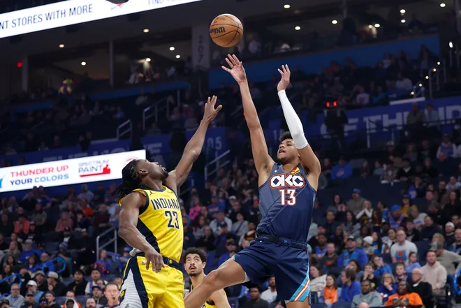 Jan 23, 2026; Oklahoma City, Oklahoma, USA; Oklahoma City Thunder forward Ousmane Dieng (13) shoots as Indiana Pacers guard/forward Aaron Nesmith (23) defends during the second quarter at Paycom Center. Mandatory Credit: Alonzo Adams-Imagn Images