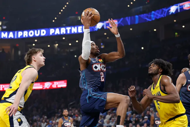 Jan 23, 2026; Oklahoma City, Oklahoma, USA; Oklahoma City Thunder guard Shai Gilgeous-Alexander (2) drives to the basket between Indiana Pacers guard Johnny Furphy (12) and Iforward Jarace Walker (5) during the first quarter at Paycom Center. Mandatory Credit: Alonzo Adams-Imagn Images