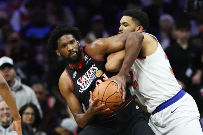 Jan 24, 2026; Philadelphia, Pennsylvania, USA; Philadelphia 76ers center Joel Embiid (21) controls the ball against New York Knicks center Karl-Anthony Towns (32) during the second quarter at Xfinity Mobile Arena. Mandatory Credit: Bill Streicher-Imagn Images