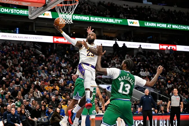 Jan 24, 2026; Dallas, Texas, USA; Los Angeles Lakers forward LeBron James (23) drives to the basket past Dallas Mavericks forward Naji Marshall (13) during the second half at the American Airlines Center.